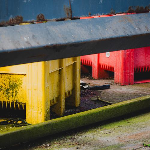 Желтый и красный ящик с синей конструкцией на переднем плане