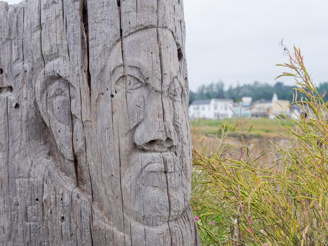 Face carved into a wooden column Face carved into a wooden column
